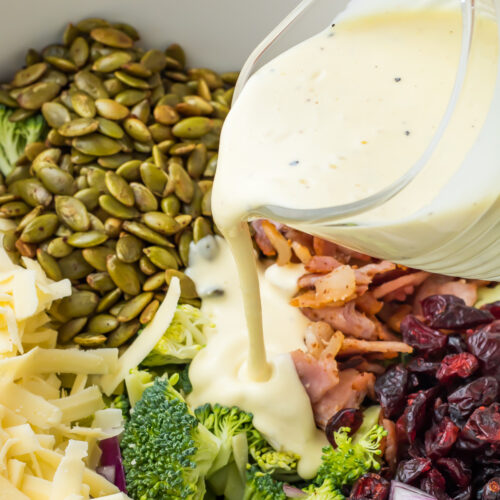 Honey Mustard Dressing being poured over salad.