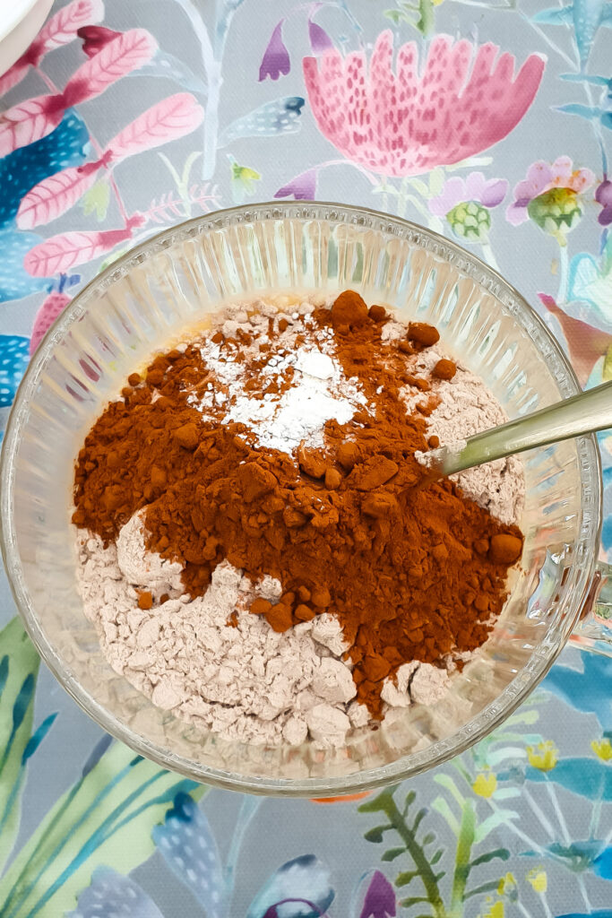 Ingredients for chocolate protein mug cake batter in a mug.