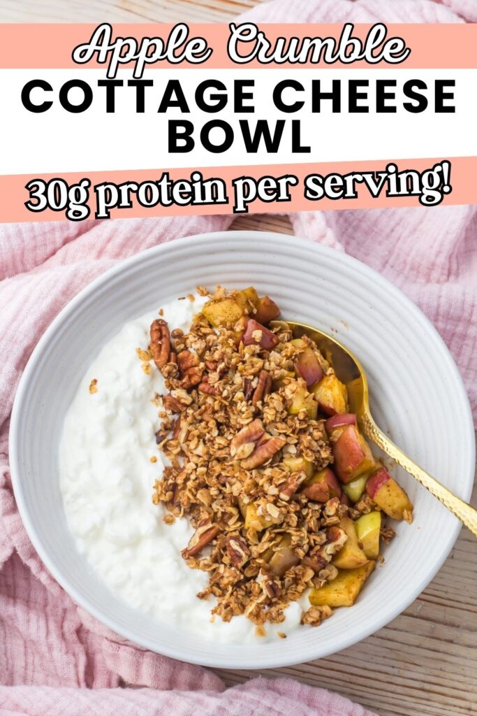 A white apple crumble Cottage Cheese Bowl filled with cottage cheese and an apple crumble mixture sits on a pink cloth beside a gold spoon. Text above highlights 30g protein per serving.